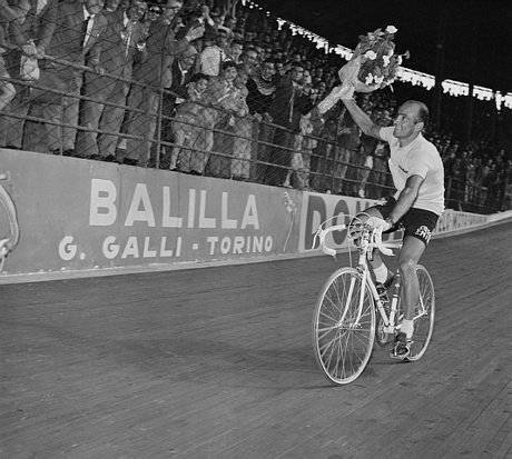 Italian Fiorenzo Magni is cheered on around Milan’s Viggorelli Velodrome after winning the 38th Giro 1955.
